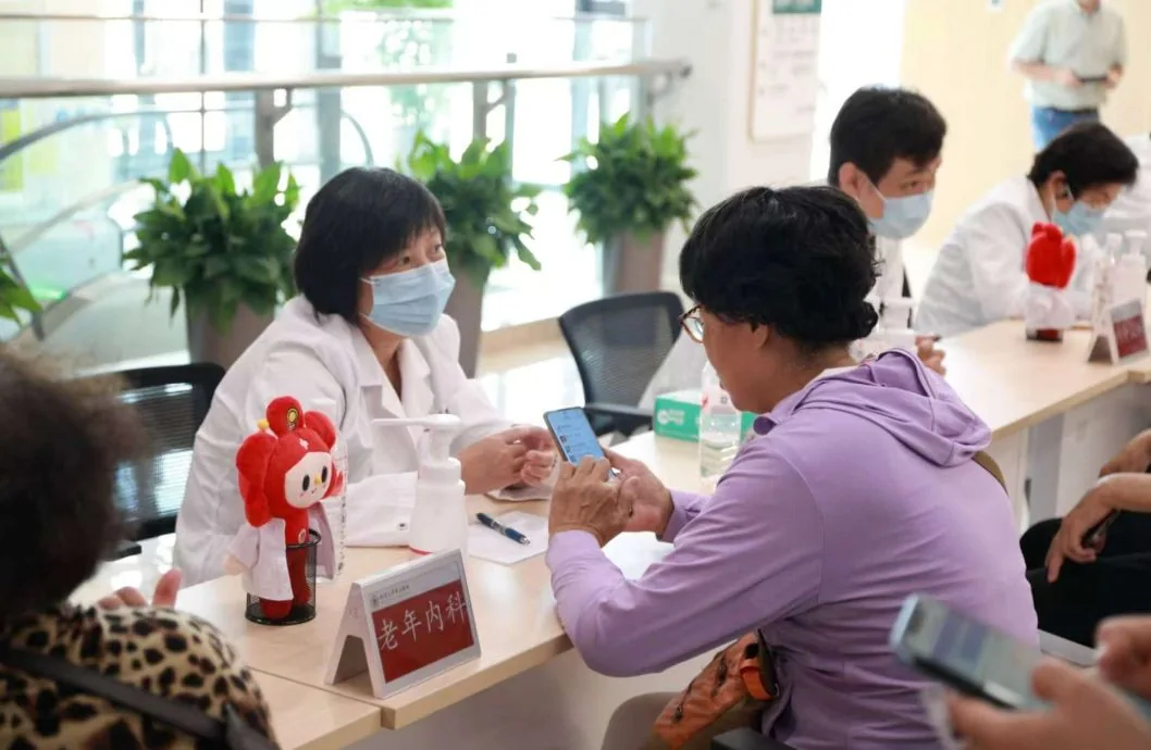 Doctor discussing care with patient at the separate Haidian North campus; not the main international clinic