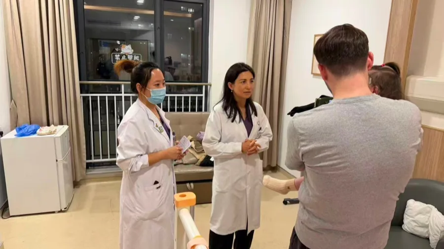 Medical staff discussing treatment with the family of an international pediatric patient in a reported case; child’s face obscured in the source