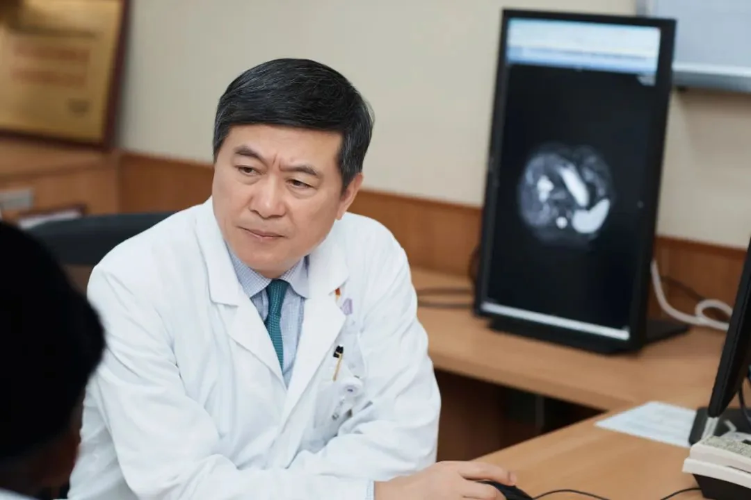 Physician reviewing imaging during an international medical department consultation shown in a hospital report published by Beijing Health Commission